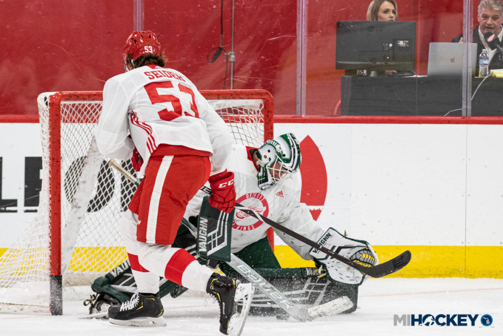 Drew DeRidder makes a save against Red Wings' first-round pick Moritz Seider. (Photo by Michael Caples/MiHockey)